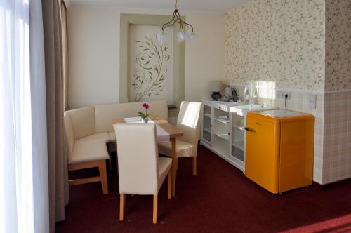 a small kitchen with a table and a yellow cabinet at Dampfschiffhotel in Stadt Wehlen