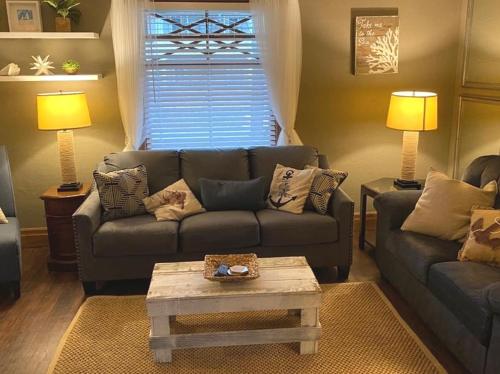 a living room with a couch and a coffee table at WALNUT Beautiful 3 bedrooms house 1 mile from the falls! in Niagara Falls