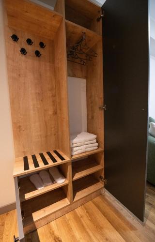 a room with a closet with wooden doors and towels at Astana Palace in Gori