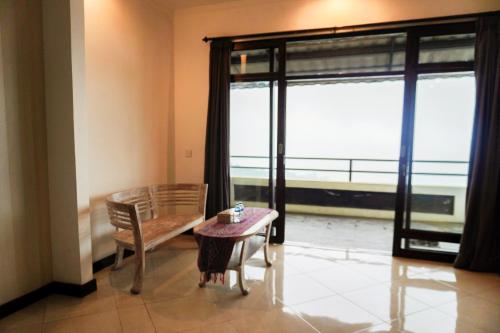 a room with a table and a chair and a window at The Kayuan in Kintamani