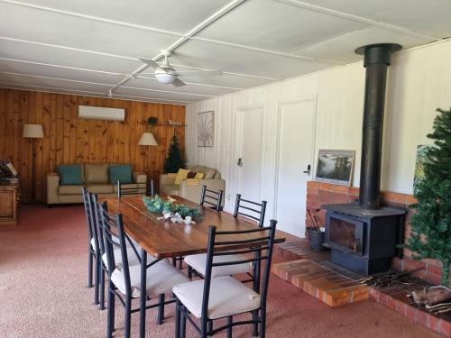 a dining room with a table and a wood stove at Tullah HideAway in Tullah