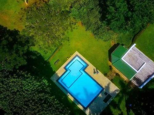 an overhead view of a swimming pool in a field at inselor Horses in Kegalle