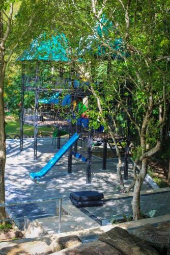a playground with a blue slide in a park at inselor Horses in Kegalle
