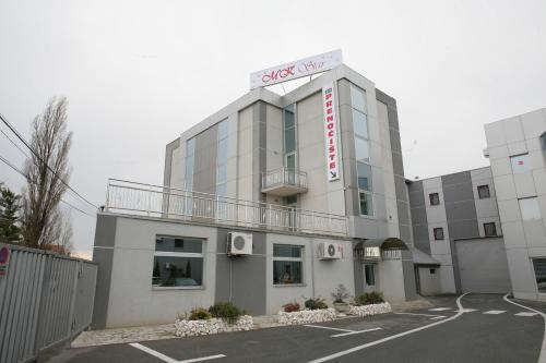 a building with a sign on top of it at Guest House MK Star in Belgrade