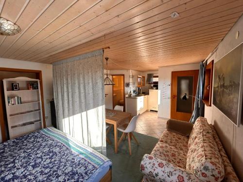 a bedroom with a bed and a living room at Blick in den Garten in Holzschlag