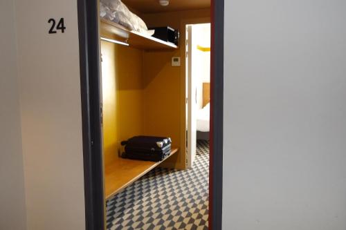 a room with a mirror and a suitcase on a shelf at La Maison des Ocres - Provence in Roussillon