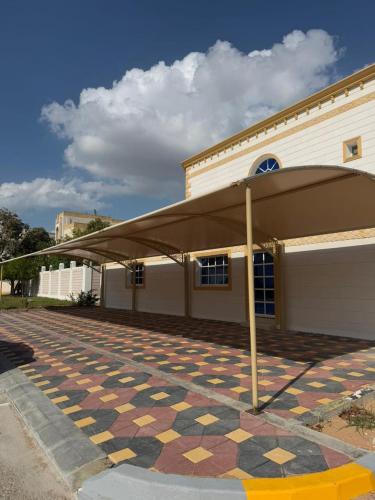 a building with a tile floor in front of a building at International Abu-Dhabi Hostel Villa in Abu Dhabi