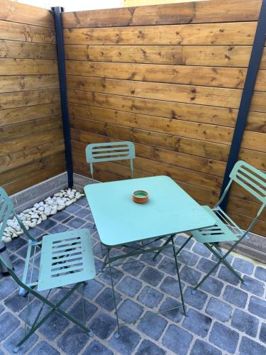 a white table and chairs on a patio at Studio Beuvry in Beuvry
