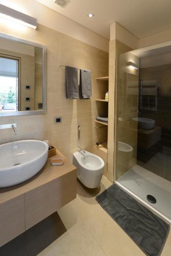 a bathroom with a tub and a sink and a shower at La Terrazza sull'Arena in Verona