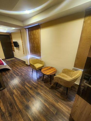 a waiting room with two chairs and a table at Arcadian Hotel in Gangtok