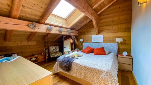 a bedroom with a bed in a wooden cabin at Chalet Grand Area in Briançon