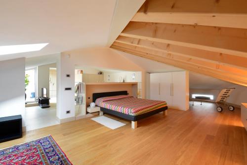 a living room with a bed and a staircase at La Terrazza sull'Arena in Verona