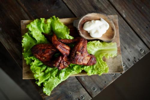 a plate with bacon lettuce and a sandwich with butter at The Kayuan in Kintamani