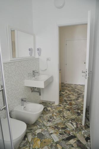 a bathroom with a sink and a toilet at La Casa di Eva in Brindisi