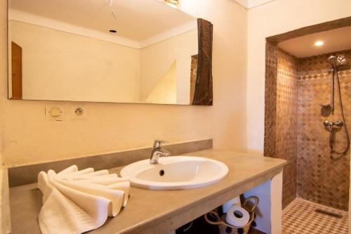 a bathroom with a sink and a shower at Eden Marrakchi in Marrakech