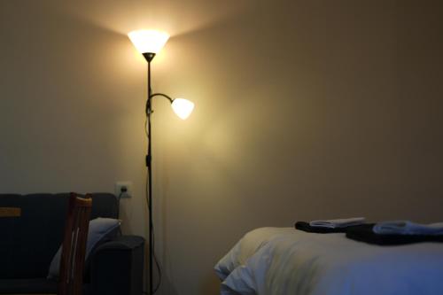 a room with a lamp next to a bed at Castle Gyumri in Gyumri