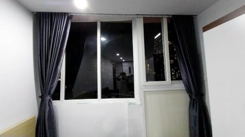 a window with black curtains in a room at 18 ngõ 154 Đình Thôn in Hanoi