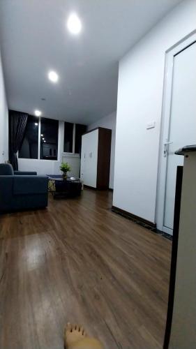 a living room with a blue couch and wooden floors at 18 ngõ 154 Đình Thôn in Hanoi
