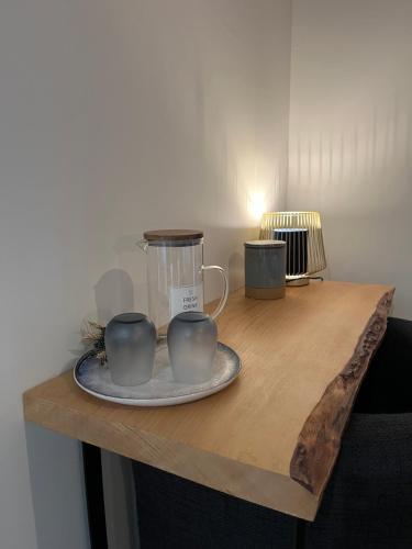 two cups on a wooden table with a blender at Domaine de la Bigottière, Chambres d'hôtes in Montigné-le-Brillant