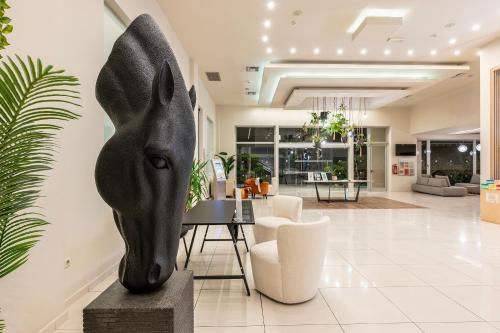 a living room with a black animal head on a table at Akti Coast Club in Marmari