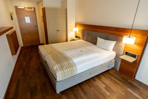 a bedroom with a large bed in a room at Restaurant Hotel Zum Storchen in Waldkirch
