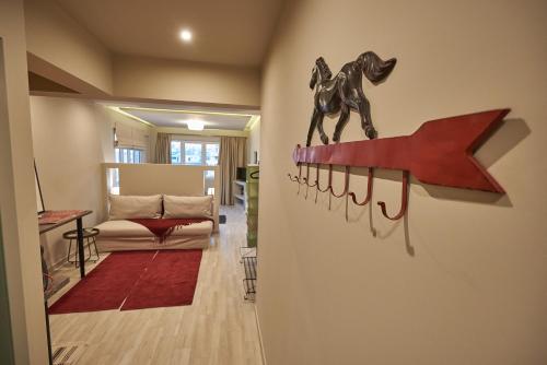 a living room with a horse on a wall at Lycabettus View Kaniggos in Athens