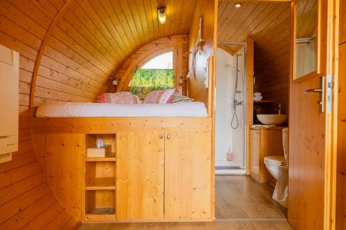 a bedroom in a tree house with a bed in it at La Ferme des Denis in Chanos-Curson
