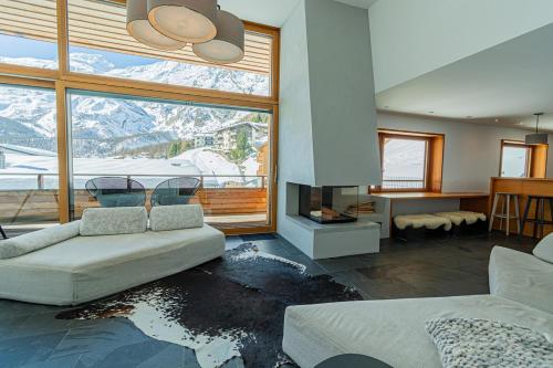 a living room with a view of a mountain at Luxury Panorama Apartment Tola in Saas-Fee
