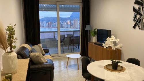 a living room with a couch and a table at Excellent apartment in front of the sea! in Benidorm