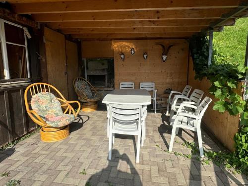 a white table and chairs on a patio at AlpenHaus, farmhouse in Triesenberg