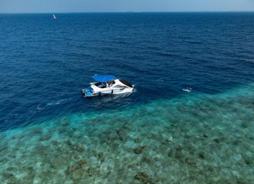 a boat floating in the water in the ocean at Bandos Maldives in North Male Atoll