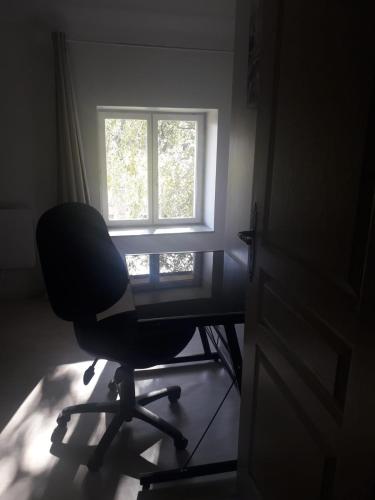 a desk with a chair in front of a window at Quiétude Vexinoise in Boury-en-Vexin