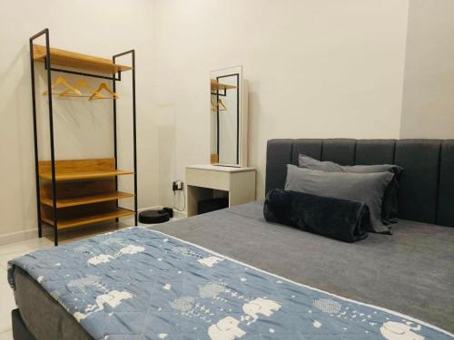 a bedroom with a bed and a mirror at GN Homes Skudai Tun Aminah - 6 Mins Sutera Mall in Skudai