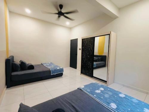 a bedroom with a bed and a ceiling fan at GN Homes Skudai Tun Aminah - 6 Mins Sutera Mall in Skudai