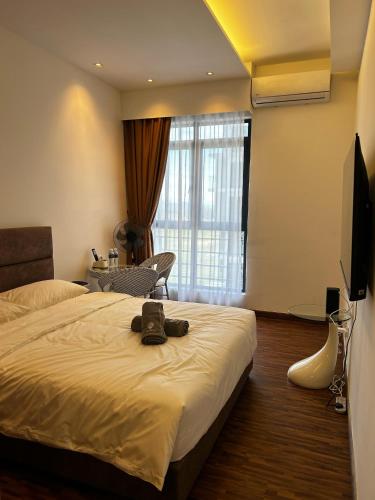 a hotel room with a bed and a television at K Avenue by Pinstay in Donggongon