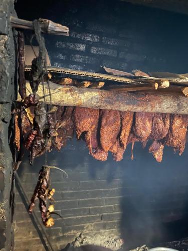 a bunch of meat is cooking on a grill at maison Rose & Jardinier eco homestay in Sa Pa