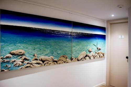 a painting of rocks on a wall at Art Studios Gialova Navarino in Gialova