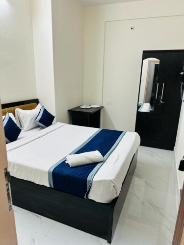 a bedroom with a large bed with blue and white sheets at S V COMFORTS B T M Layout in Bengaluru