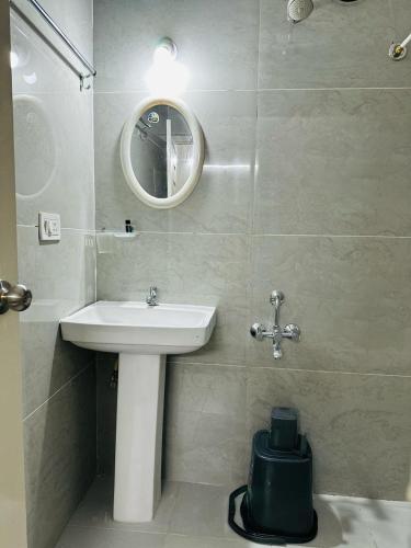 a bathroom with a sink and a mirror at S V COMFORTS B T M Layout in Bengaluru