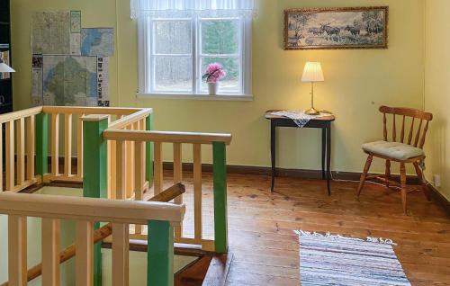 a room with a staircase and a chair and a window at Nice Apartment In Mantorp With Kitchen in Mantorp