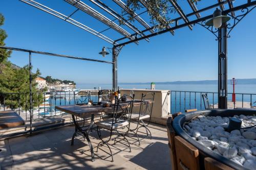 a patio with a table and chairs on a balcony at Newly renovated Hotel Kastil in Bol