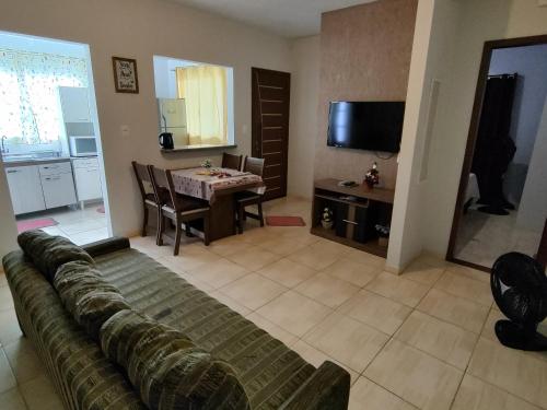 a living room with a couch and a table at Apto com jeito de casa entre o mar e a montanha in Florianópolis