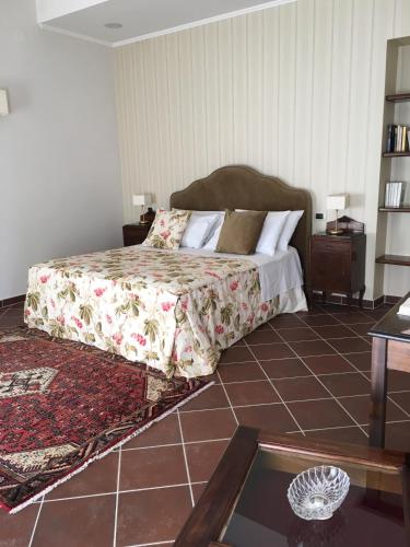 a bedroom with a bed and a tiled floor at Il Casale di Riardo Luxury B&B in Riardo