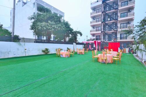 a group of tables and chairs on a field of grass at Orsom Stays Sassy Sector 53 in Gurgaon