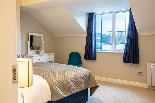 a bedroom with a bed and a window and a chair at No 31 Killarney Holiday Village in Killarney