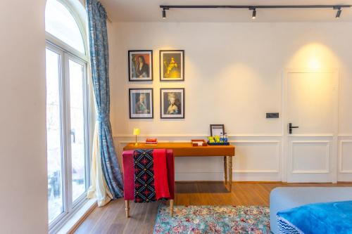 a living room with a table and a window at The Zoey Villa, with Central Heating, Bonfire, BBQ & Complimentary Breakfast in Gulmarg