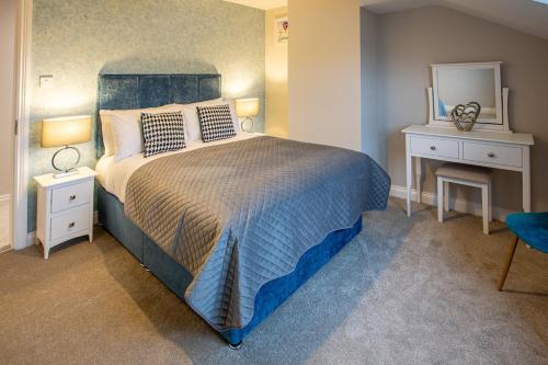 a bedroom with a large bed and a mirror at No 31 Killarney Holiday Village in Killarney