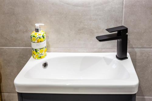 a white sink with a bottle of soap on it at No 31 Killarney Holiday Village in Killarney