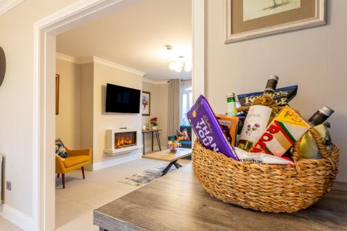 a basket of food and drinks on a table in a living room at No 31 Killarney Holiday Village in Killarney