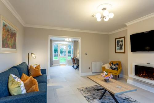 a living room with a blue couch and a fireplace at No 31 Killarney Holiday Village in Killarney